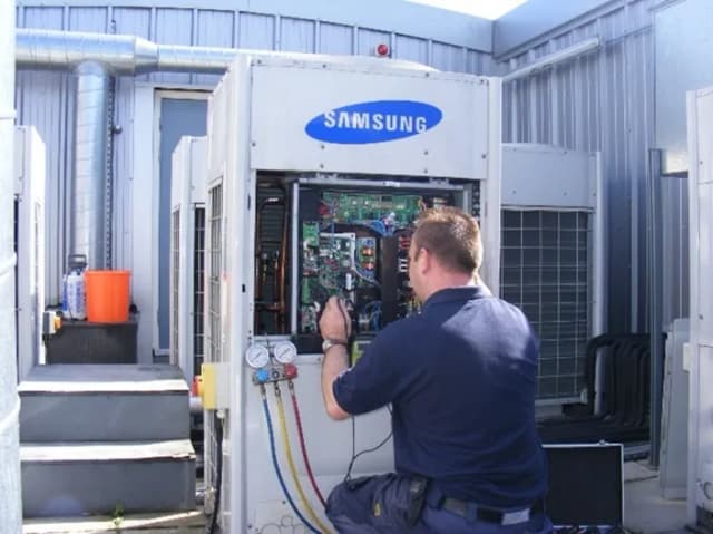 Refcool technician performing preventative maintenance on Samsung chiller unit